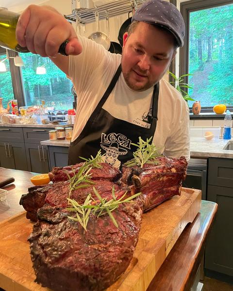 Chef Alex torching prime rib at public culinary event